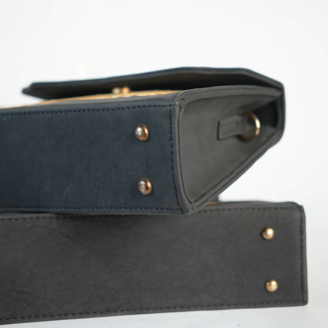 Close-up of stitching and gold base studs