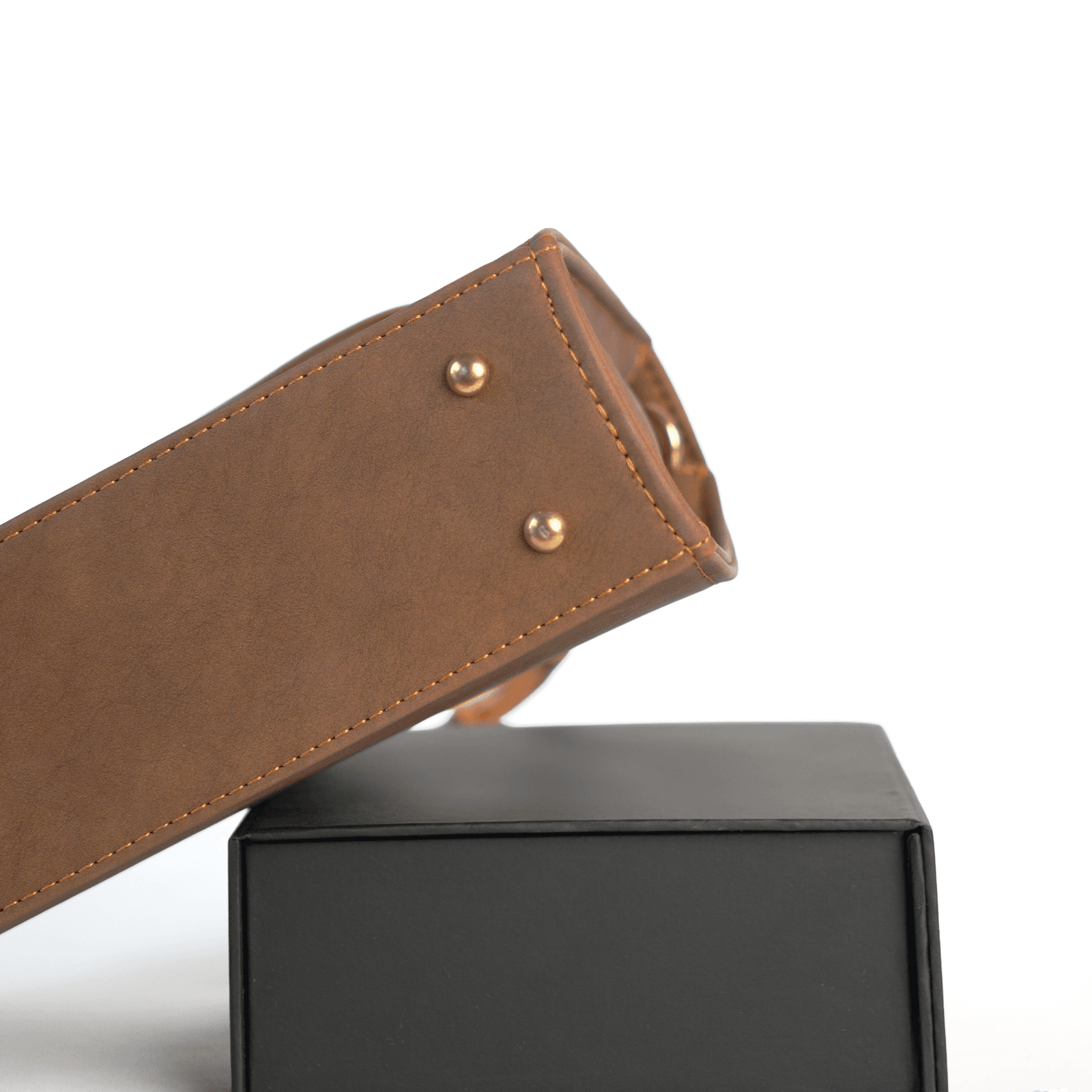 Close-up of the brown Taaq bag base with metal feet