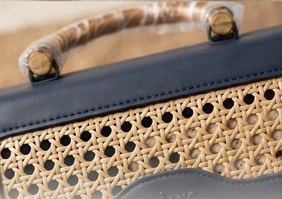 Close-up of hand-woven cane set into navy leather